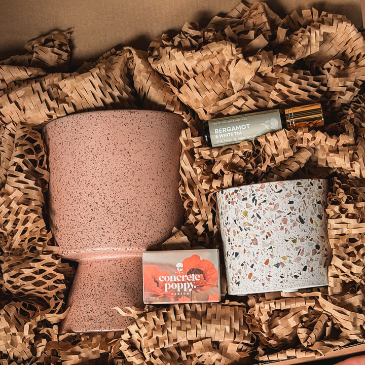 Exhale Deluxe candle gift set by Concrete Poppy Design with Hali dusty rose ceramic and Nico terrazzo soy candles, roll-on perfume oil and matches