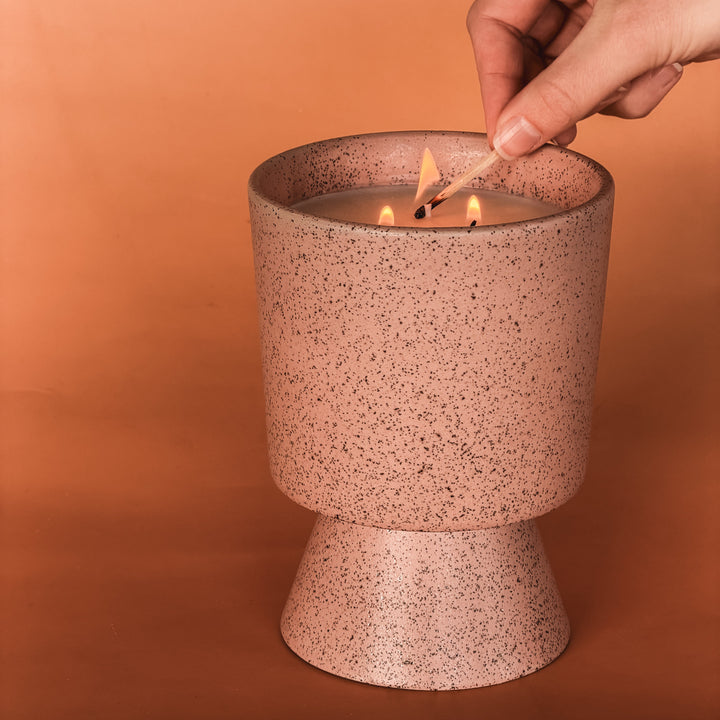 Hali triple-wick soy candle by Concrete Poppy Design in speckled dusty rose ceramic pedestal vessel, handmade in Denver with wildflower seeds