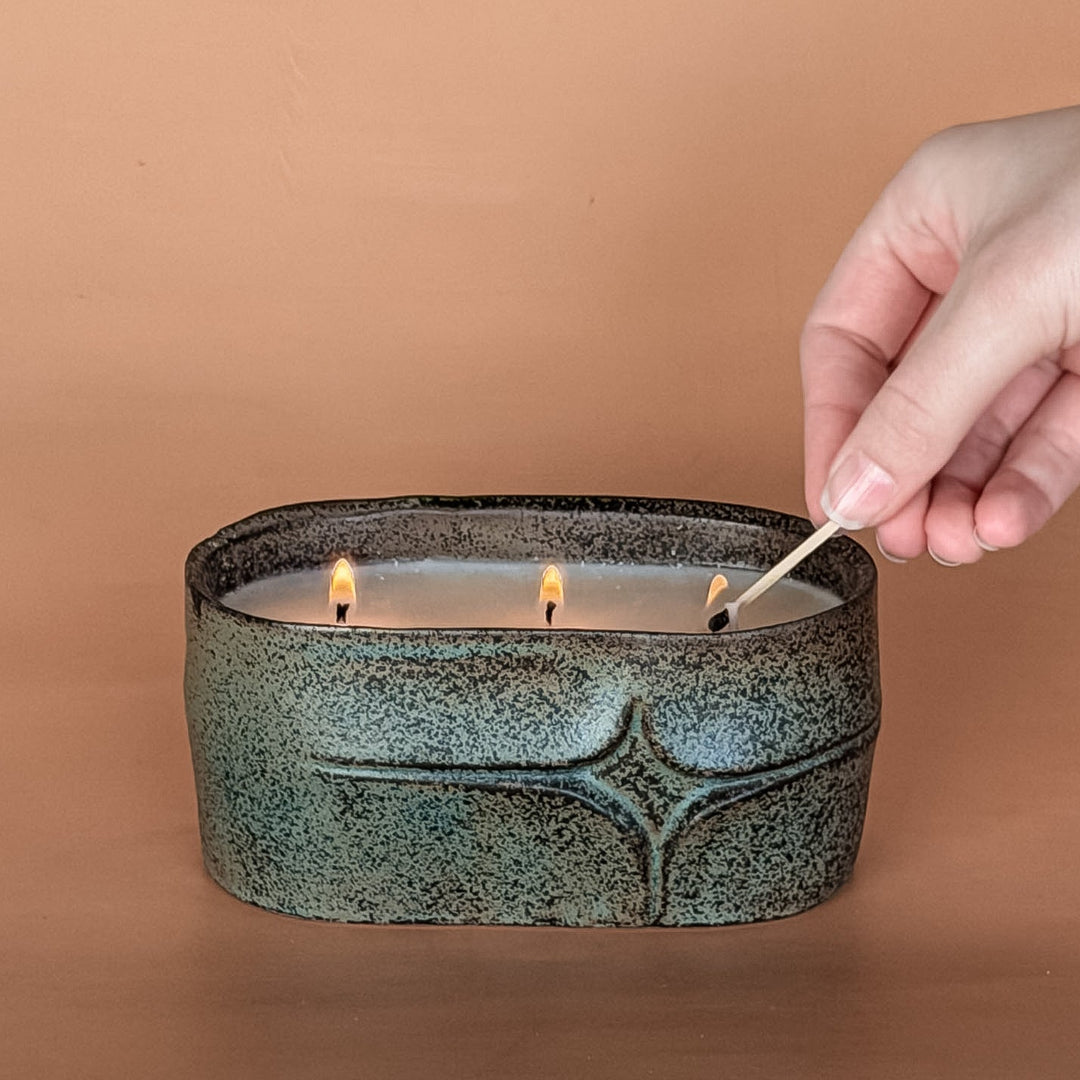 Non-toxic handcrafted soy candle in rustic green ceramic oval vessel, reusable planter candle with wildflower seed packet
