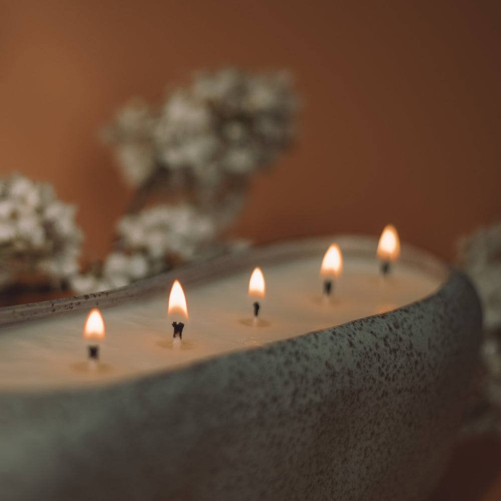 Concrete Poppy Design large non-toxic soy candle in long oval speckled gray ceramic vessel with wildflower seeds
